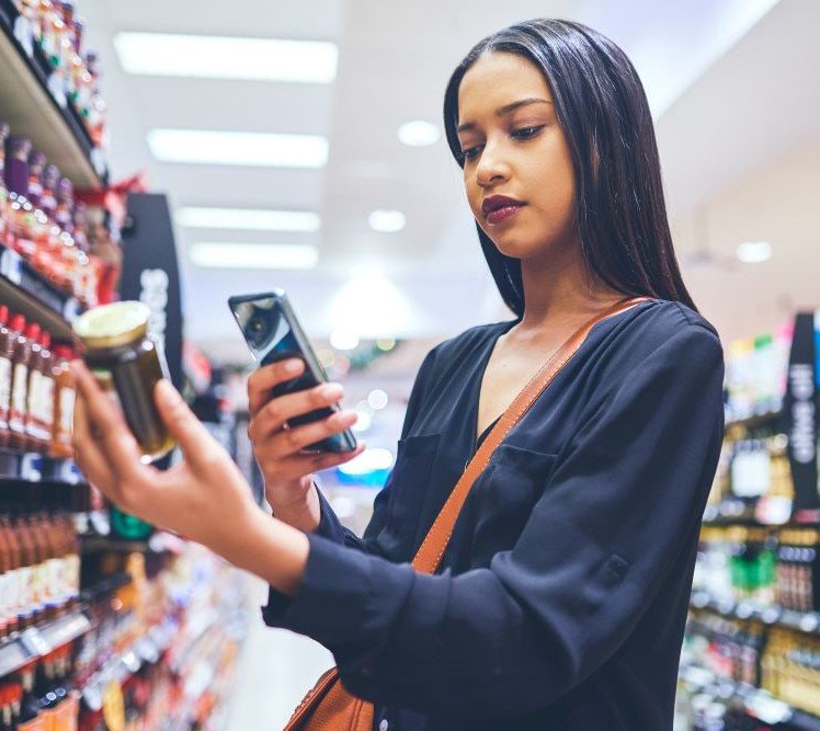 Femme vérifiant la composition d'un produit cosmétique